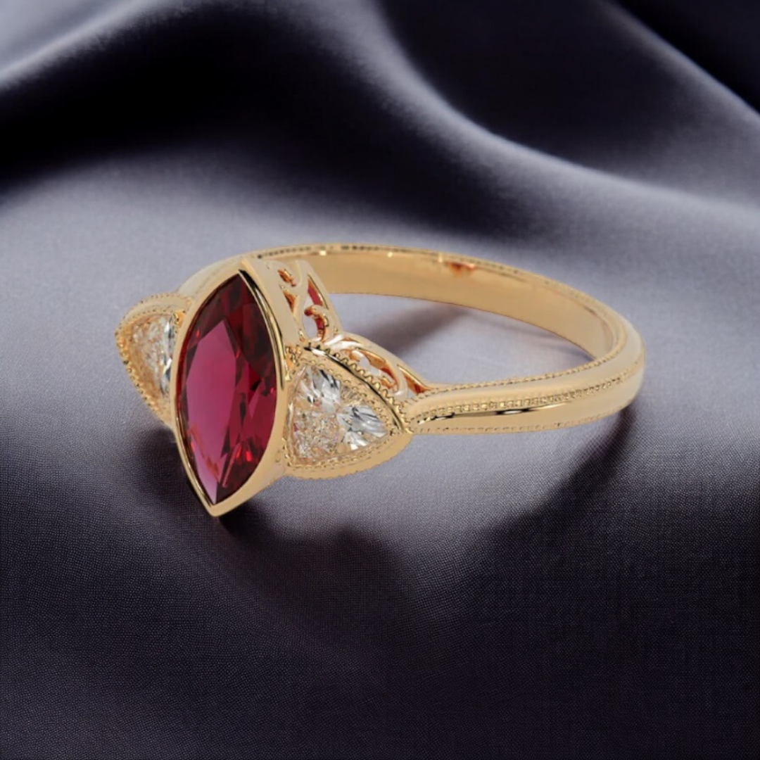 Hypnotic Ring in 14k yellow gold with marquise cut lab created ruby and trillion cut lab created diamonds, bezel set with milgrain detailing