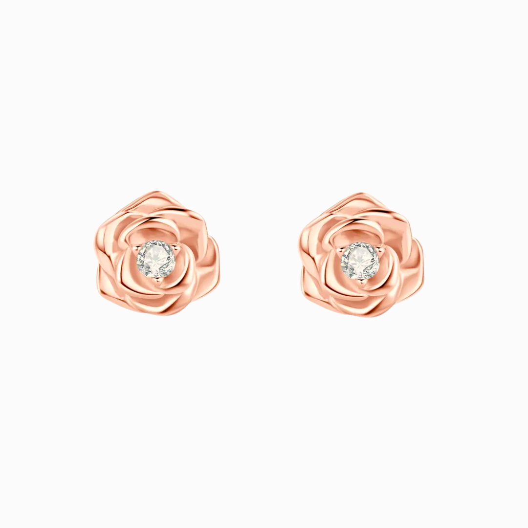 A pair of sculpted rose stud earrings in white gold or rose gold-plated sterling silver, each featuring a brilliant moissanite center stone.