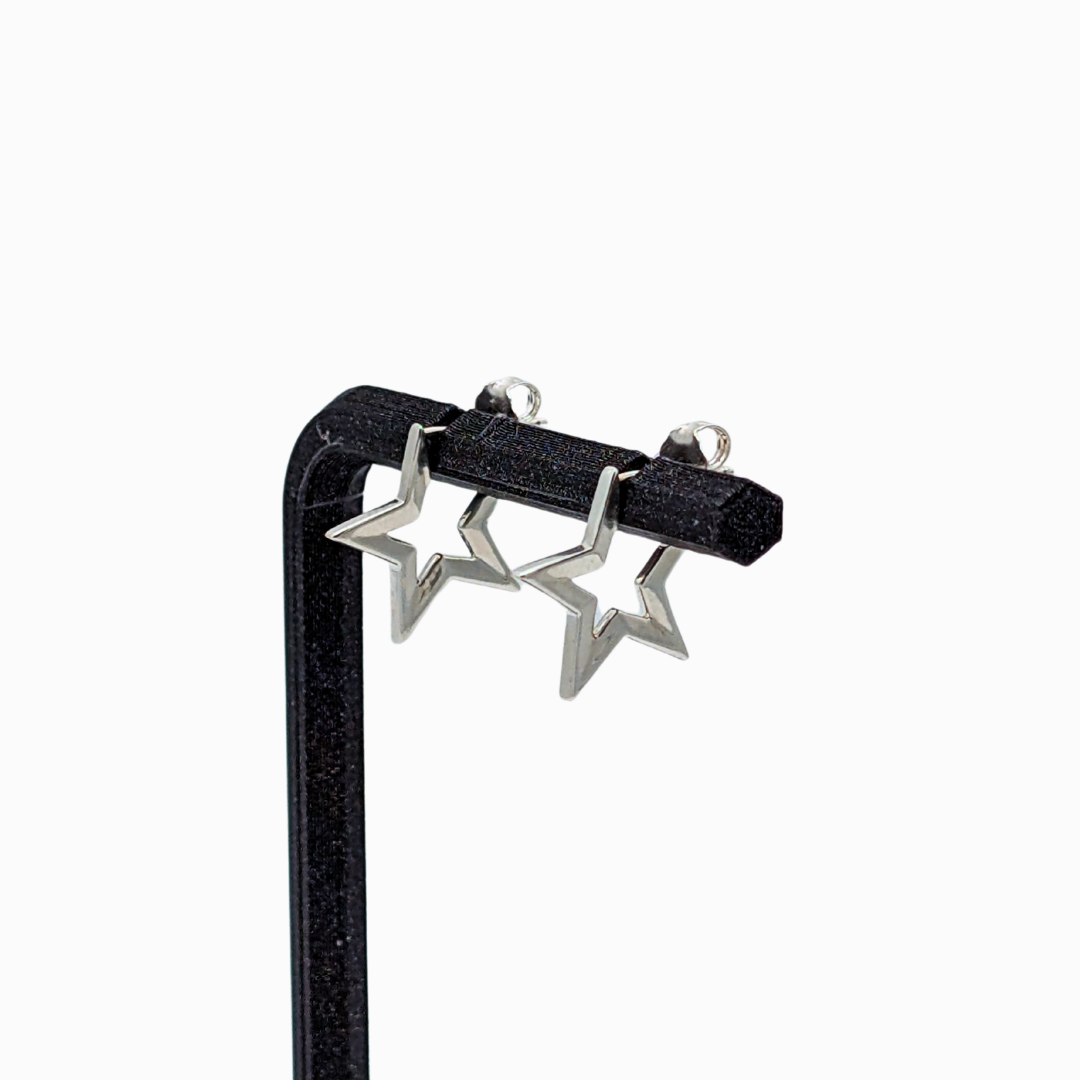 White gold Starburst Earrings with open-star design on earring stand