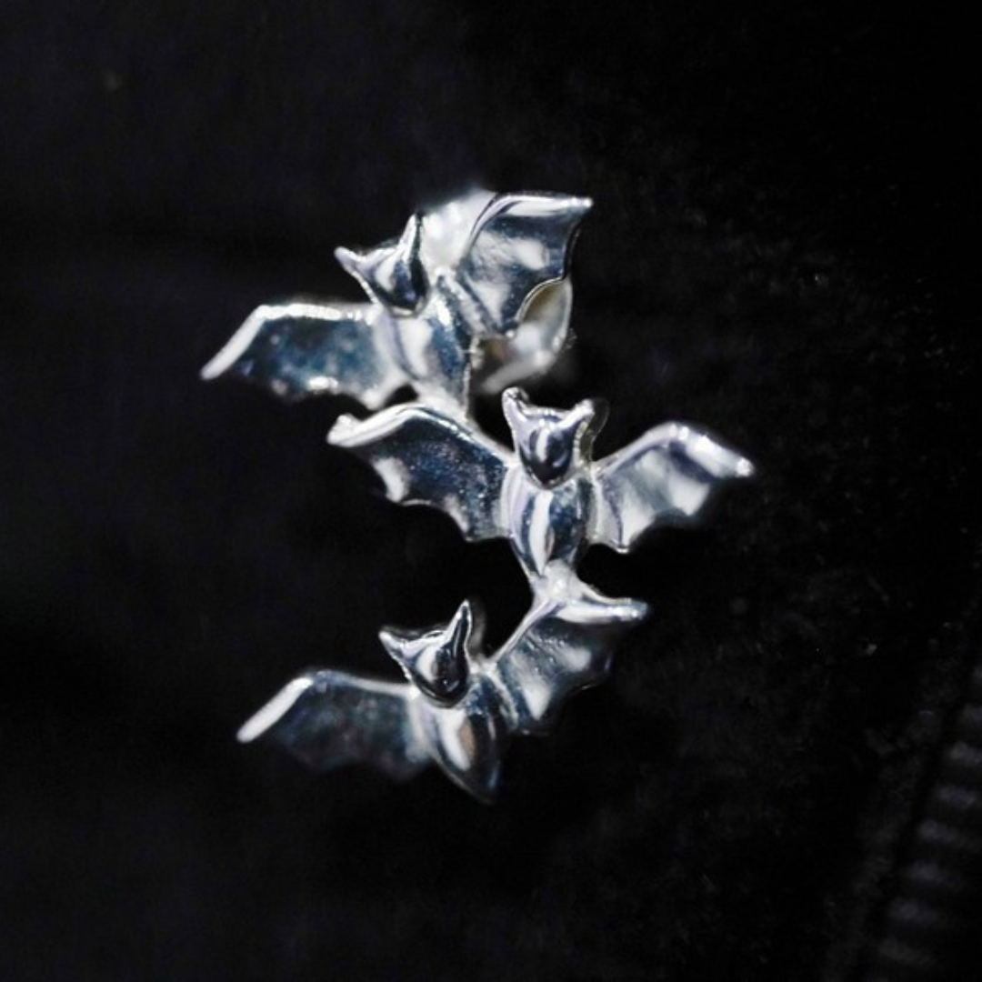 Sterling silver earrings featuring three intricately detailed bats in a cascading formation, Bewitching Bat Earrings